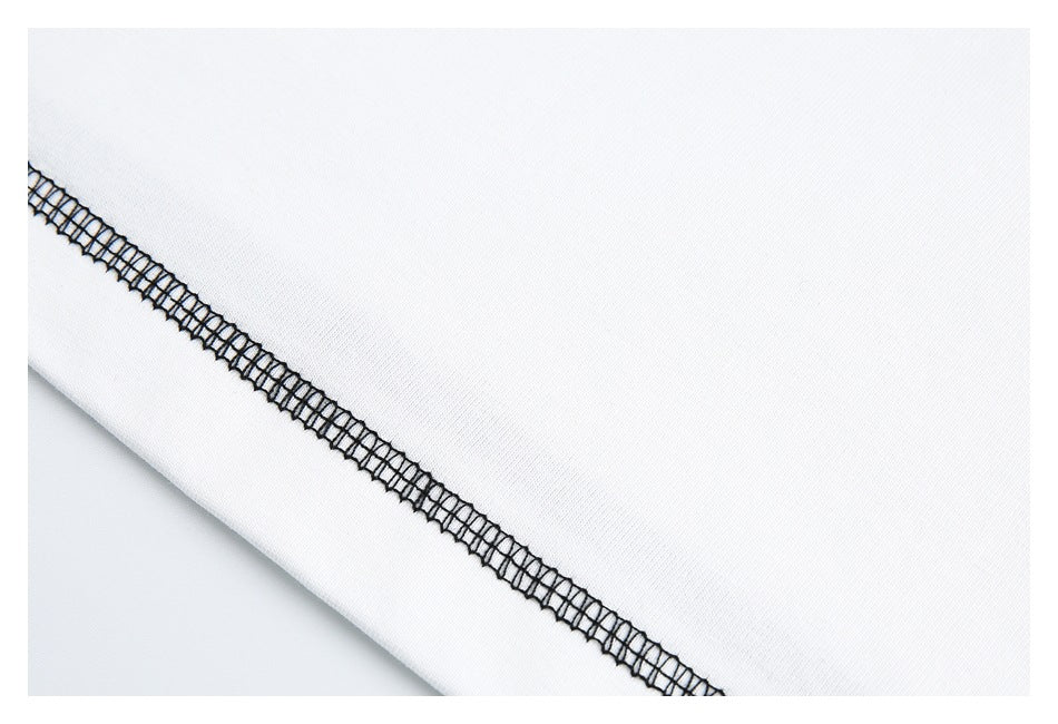 Close-up of a diagonal black overlock seam on white garment fabric.