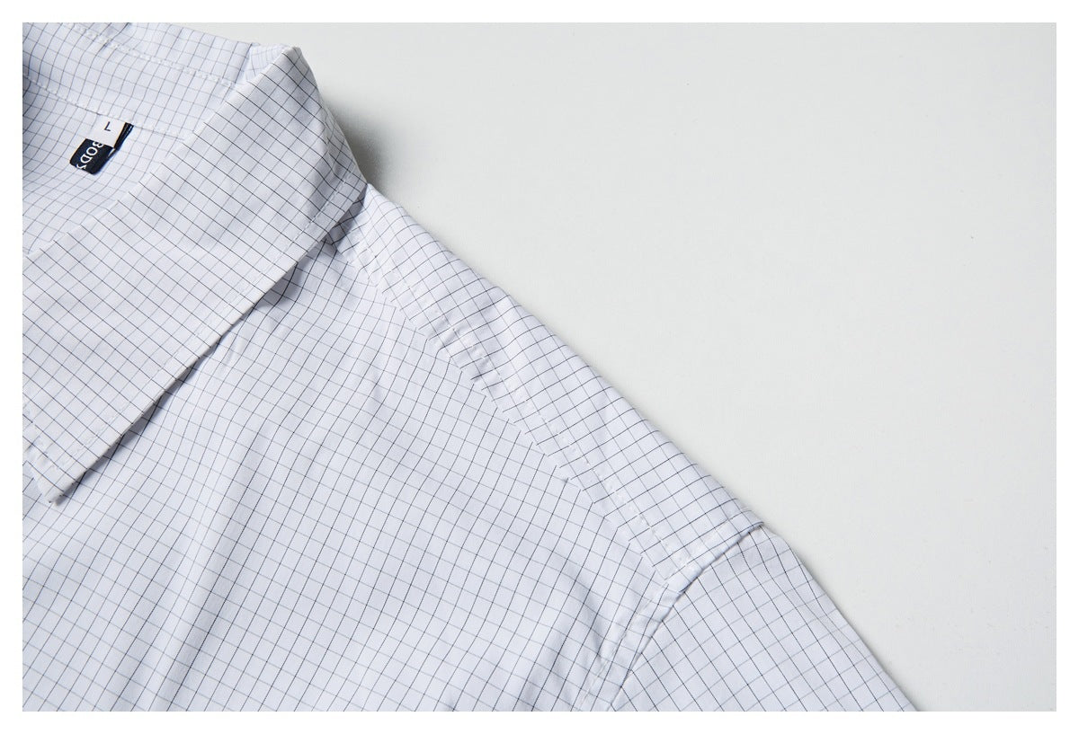 Close-up of the white grid-check shirt showing its collar, shoulder seam, and upper sleeve.