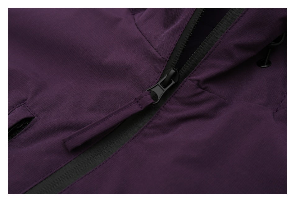 Close-up of the deep-purple jacket's black front zipper and pull.