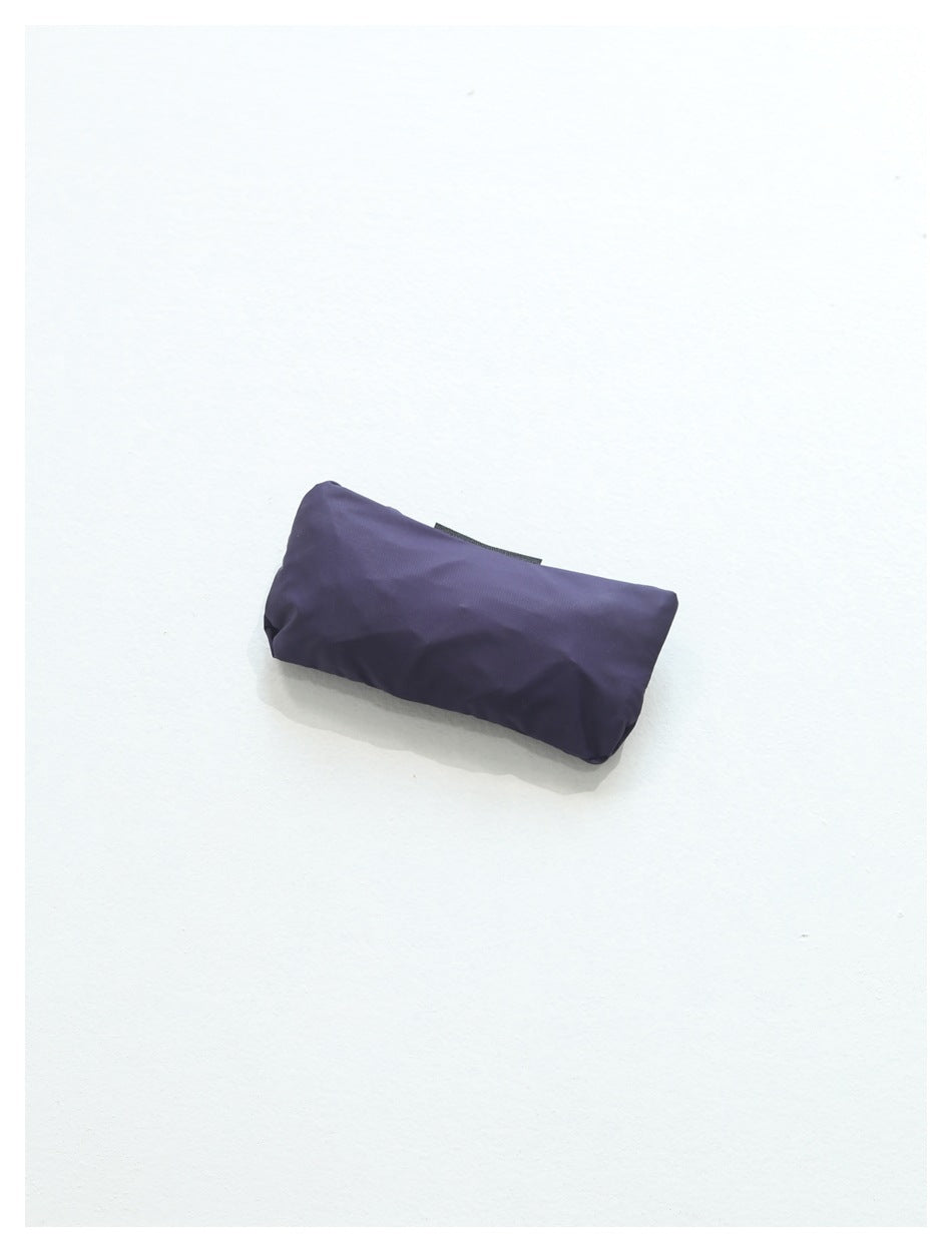 Compact purple bag folded flat on a white background.