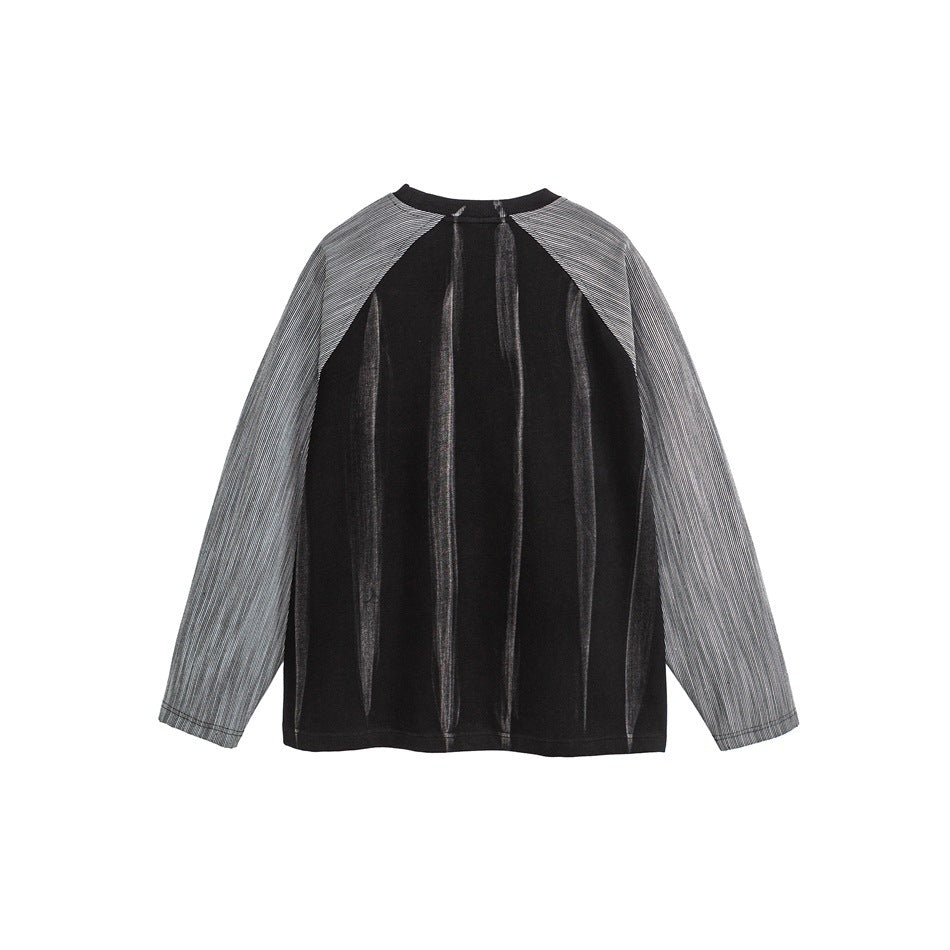 Back view of a black long-sleeve top with gray pinstriped raglan sleeves and vertical tonal detailing.