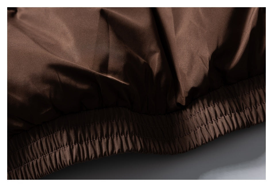Close-up of the brown jacket's gathered elastic hem and stitching.