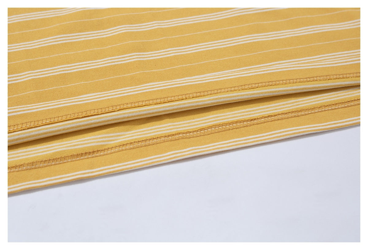 Close-up of the stitched hem on a mustard yellow T-shirt with thin white horizontal stripes.