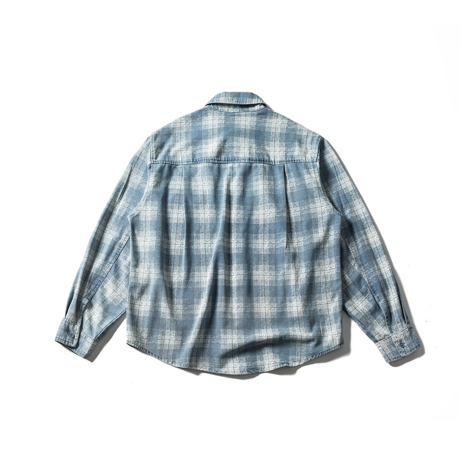 Back view of washed blue and cream plaid long-sleeve shirt flat lay showing yoke seam, center pleat and buttoned cuffs
