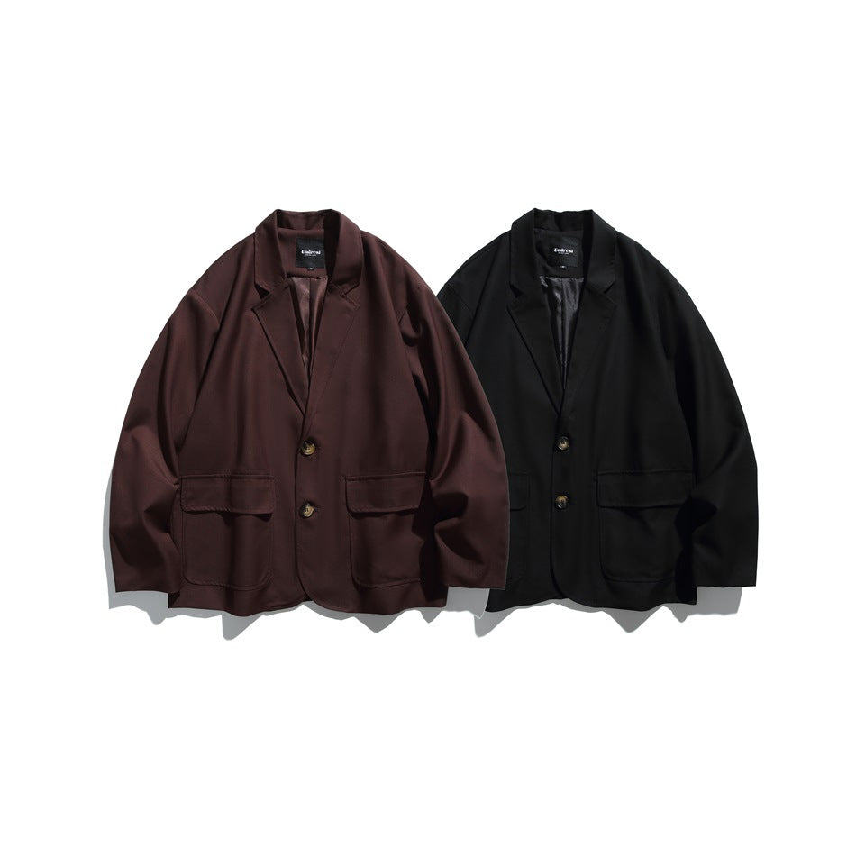 Front view of two blazers with notched lapels and patch pockets, one burgundy and one black.