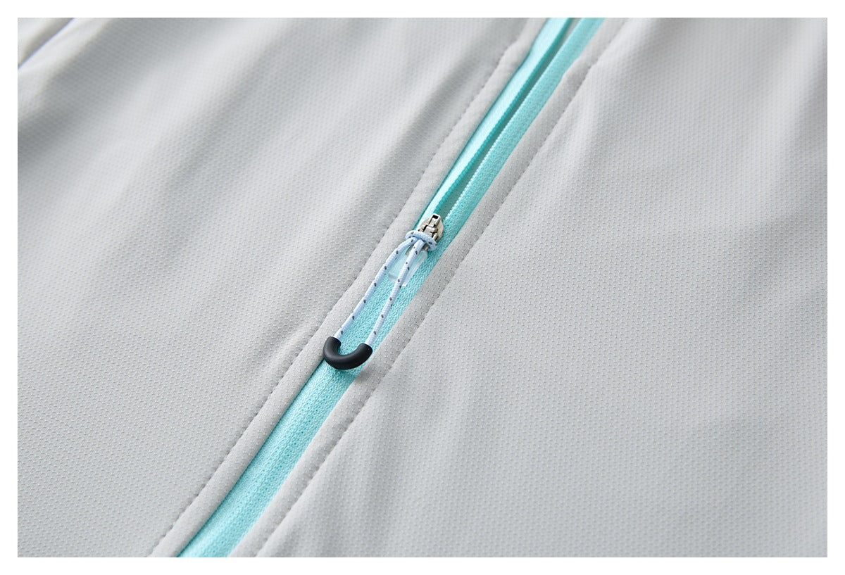 Close-up of a turquoise front zipper with a cord pull on a light gray perforated garment.