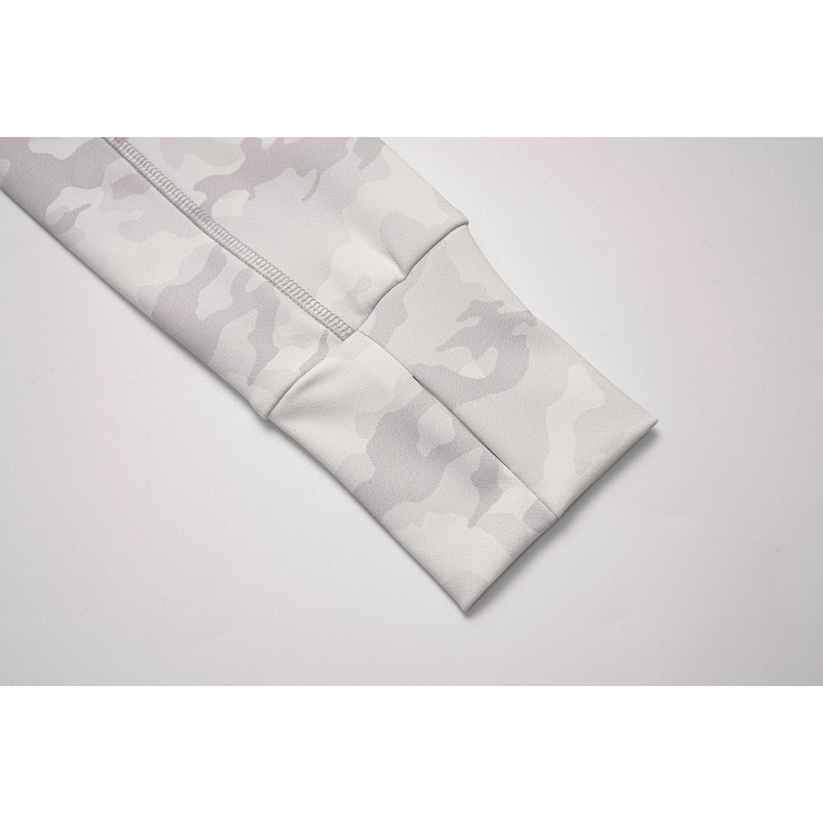 Close-up of the white camouflage jacket sleeve cuff and seam stitching.