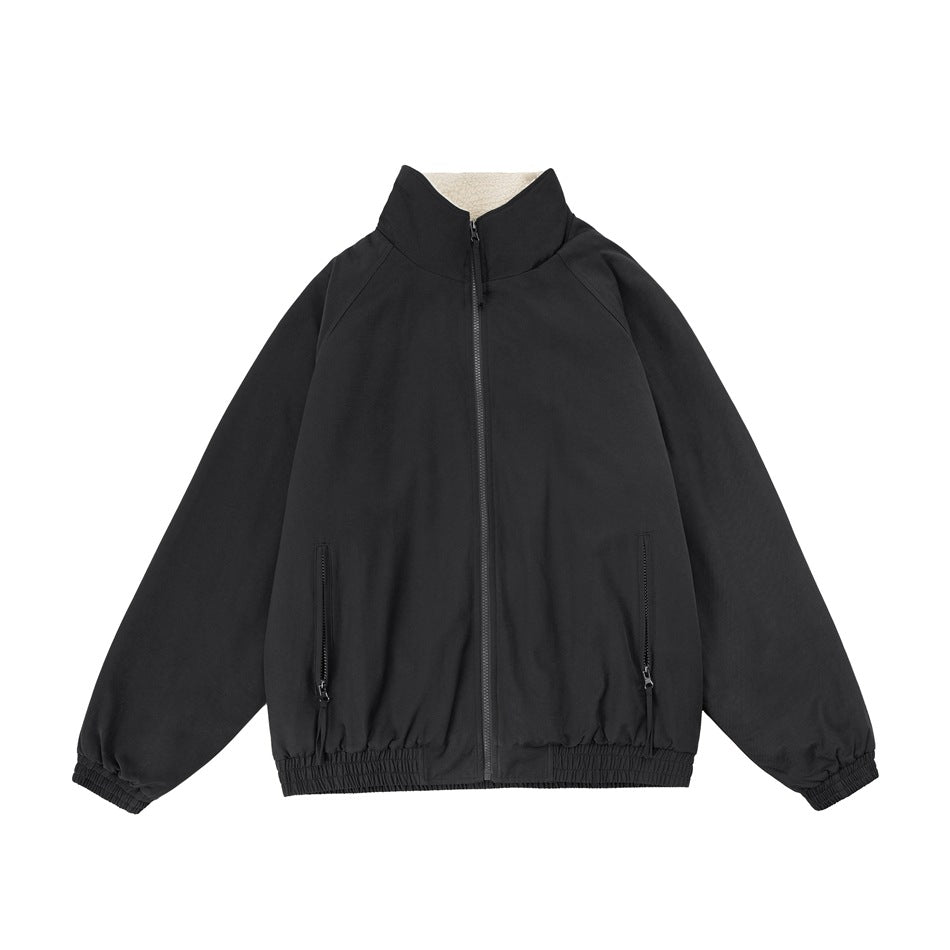Black zip-front jacket with stand collar, cream fleece-like collar lining, zip pockets and elastic cuffs and hem