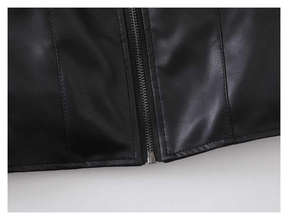 Close-up of the black jacket's front zipper and stitched lower hem.