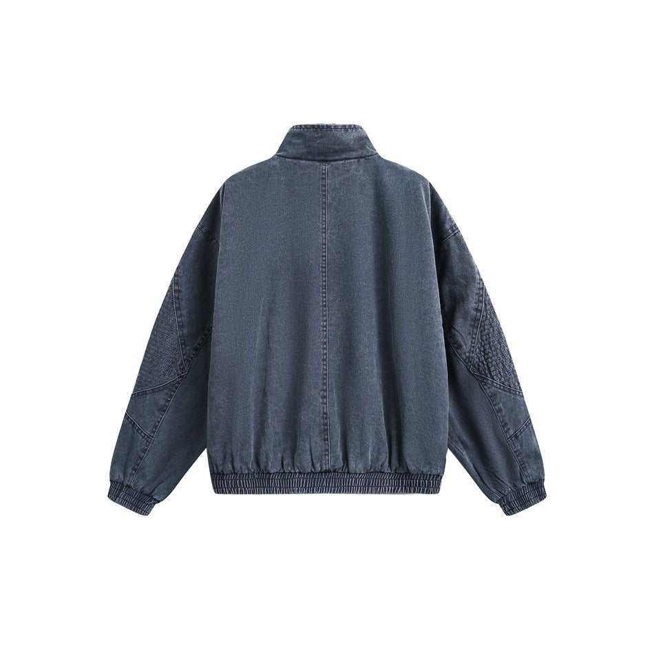 Back view of a dark blue jacket with a stand collar, center seam, paneled sleeves, and elastic hem and cuffs.