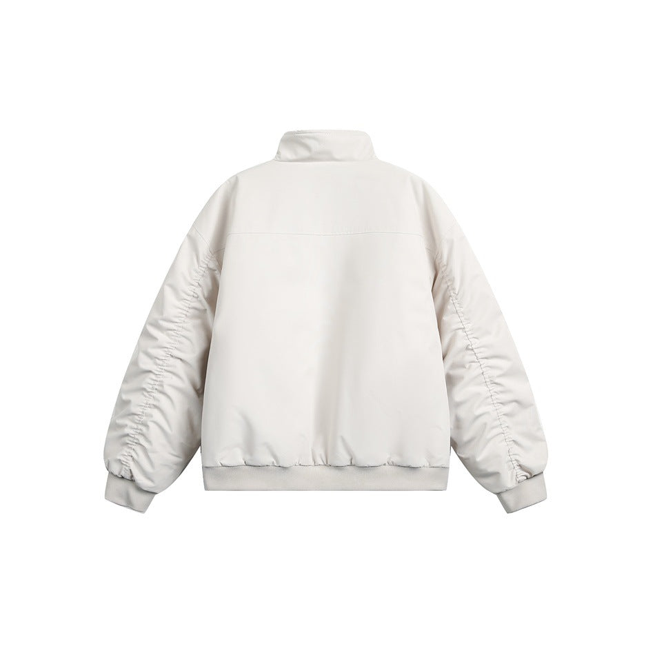 Back view of an off-white jacket with a stand collar, gathered sleeves, and ribbed cuffs and hem.