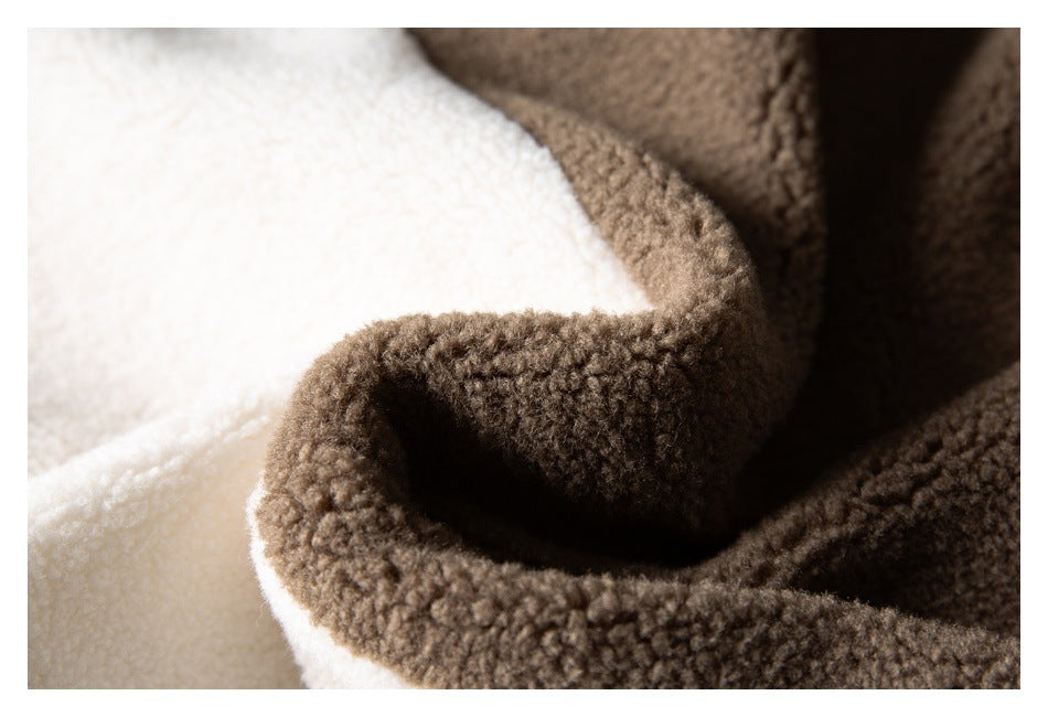 Close-up of a brown fuzzy garment folded over cream fabric.