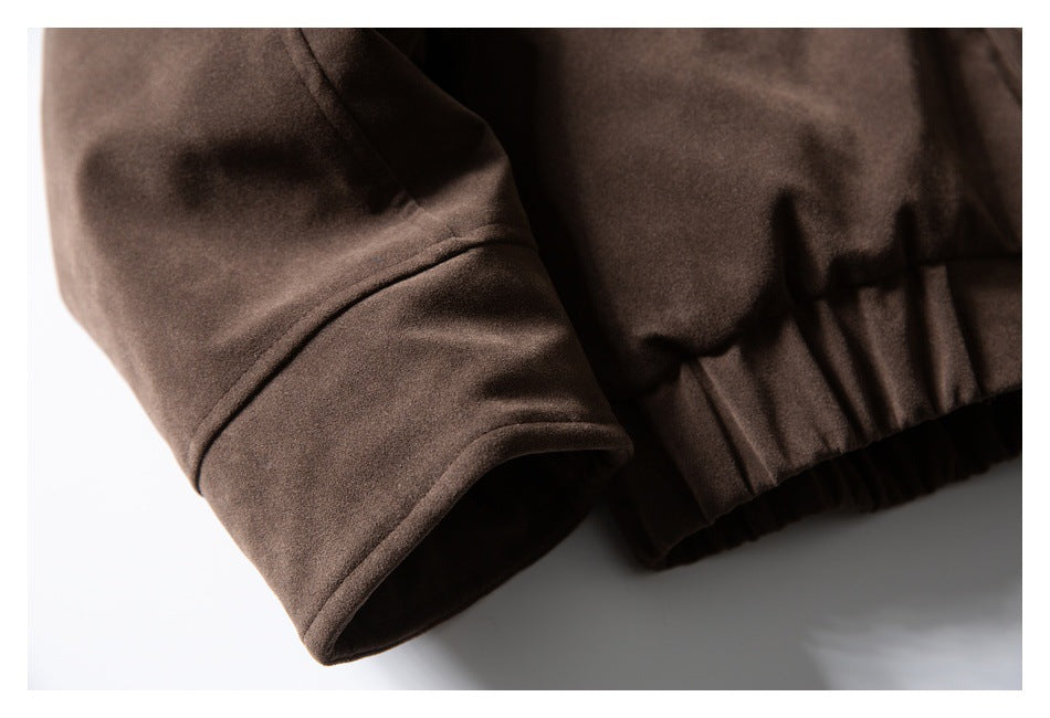 Close-up of a dark brown jacket sleeve cuff and gathered lower hem.