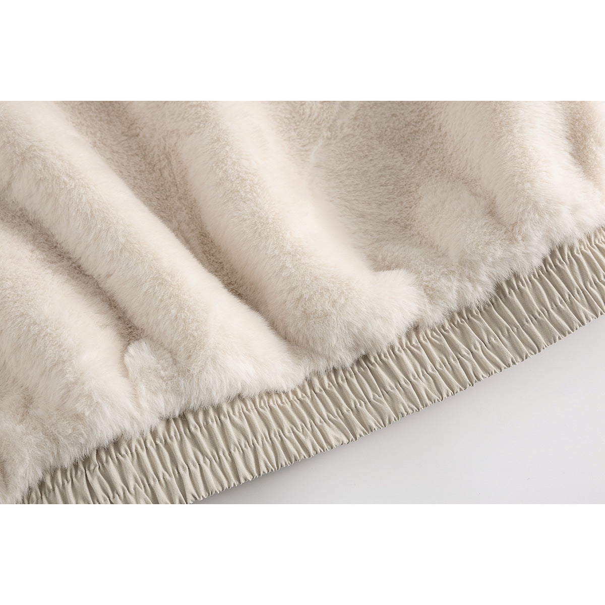Close-up of the cream plush jacket lining and gathered beige hem.