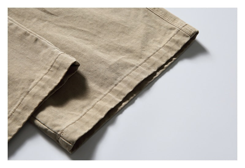 Close-up of the stitched hem on a beige garment.