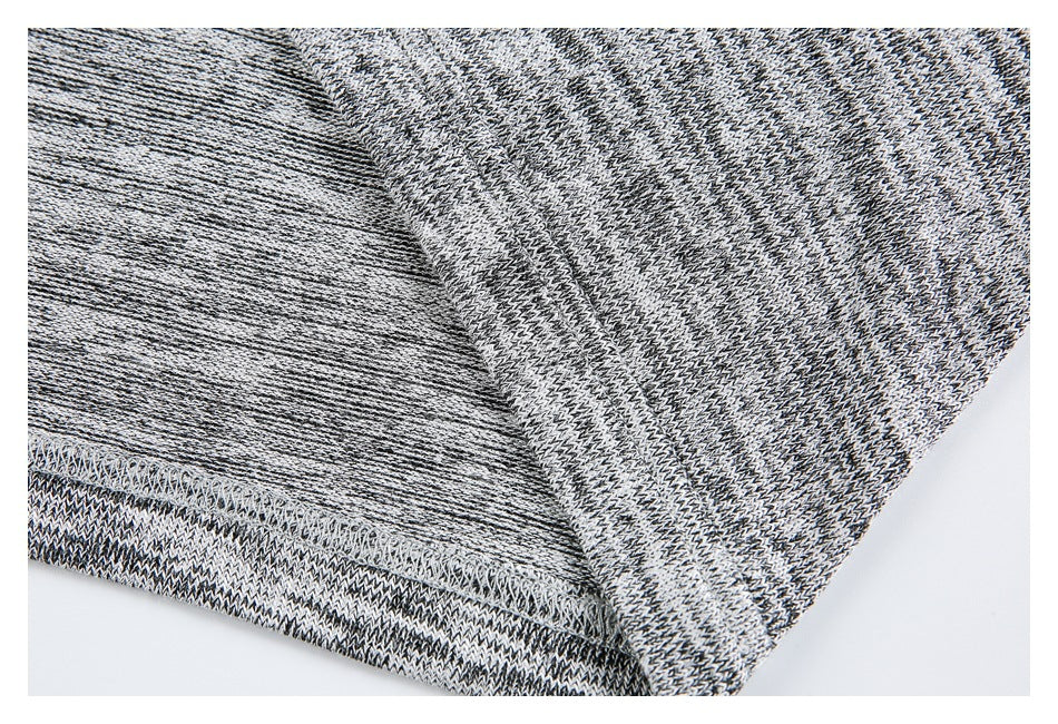 Close-up of the garment's folded edge and overlock stitching against the marled knit.