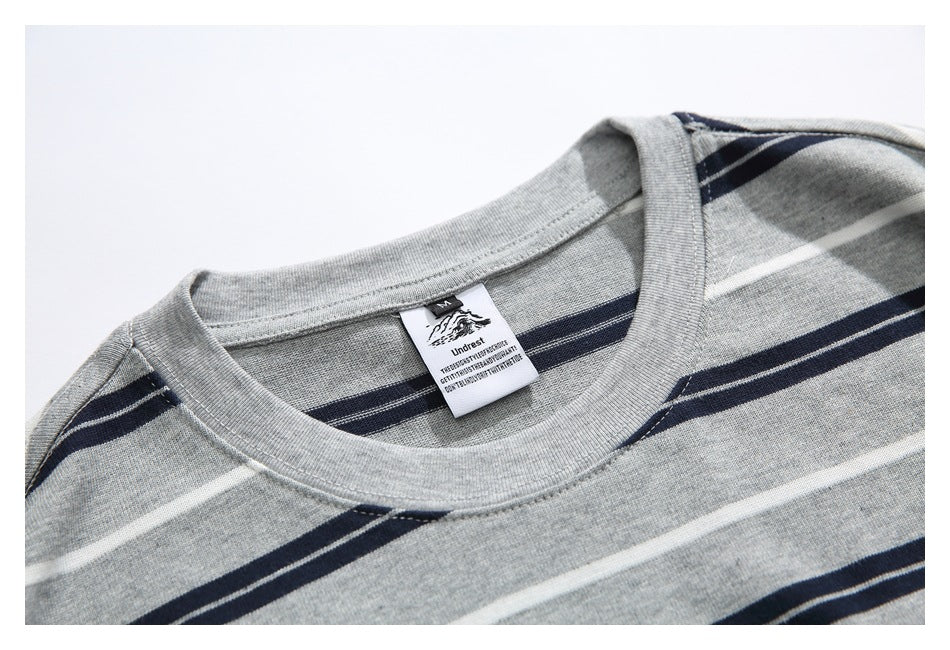Close-up of the gray striped T-shirt's crew neckline and sewn-in label.