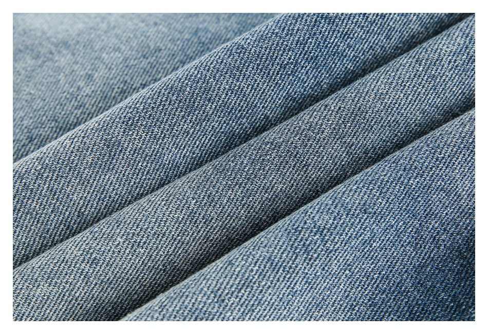 Macro view of textured blue denim folded into soft ridges.