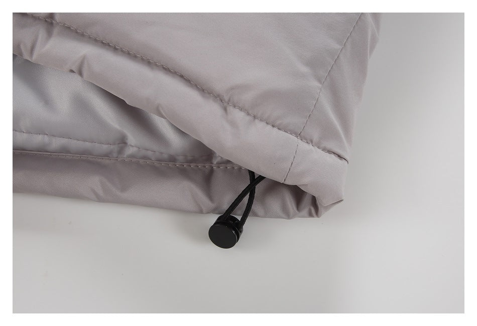 Close-up of the light gray garment hem with a black elastic drawcord toggle.