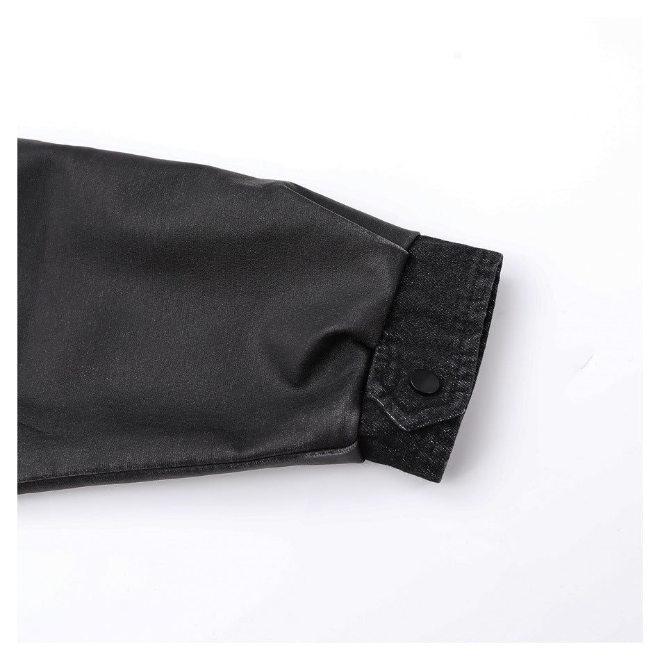 Close-up of a black jacket sleeve ending in a contrasting cuff with a black snap button.