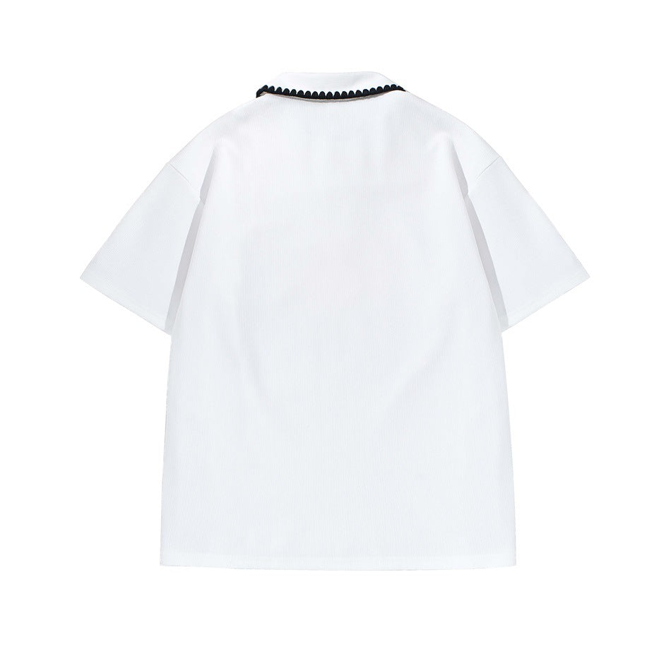 Back view of a white short-sleeve polo shirt with black scalloped trim along the collar.