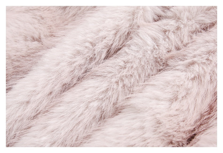 Close-up showing the long, pale blush fur texture of the jacket.