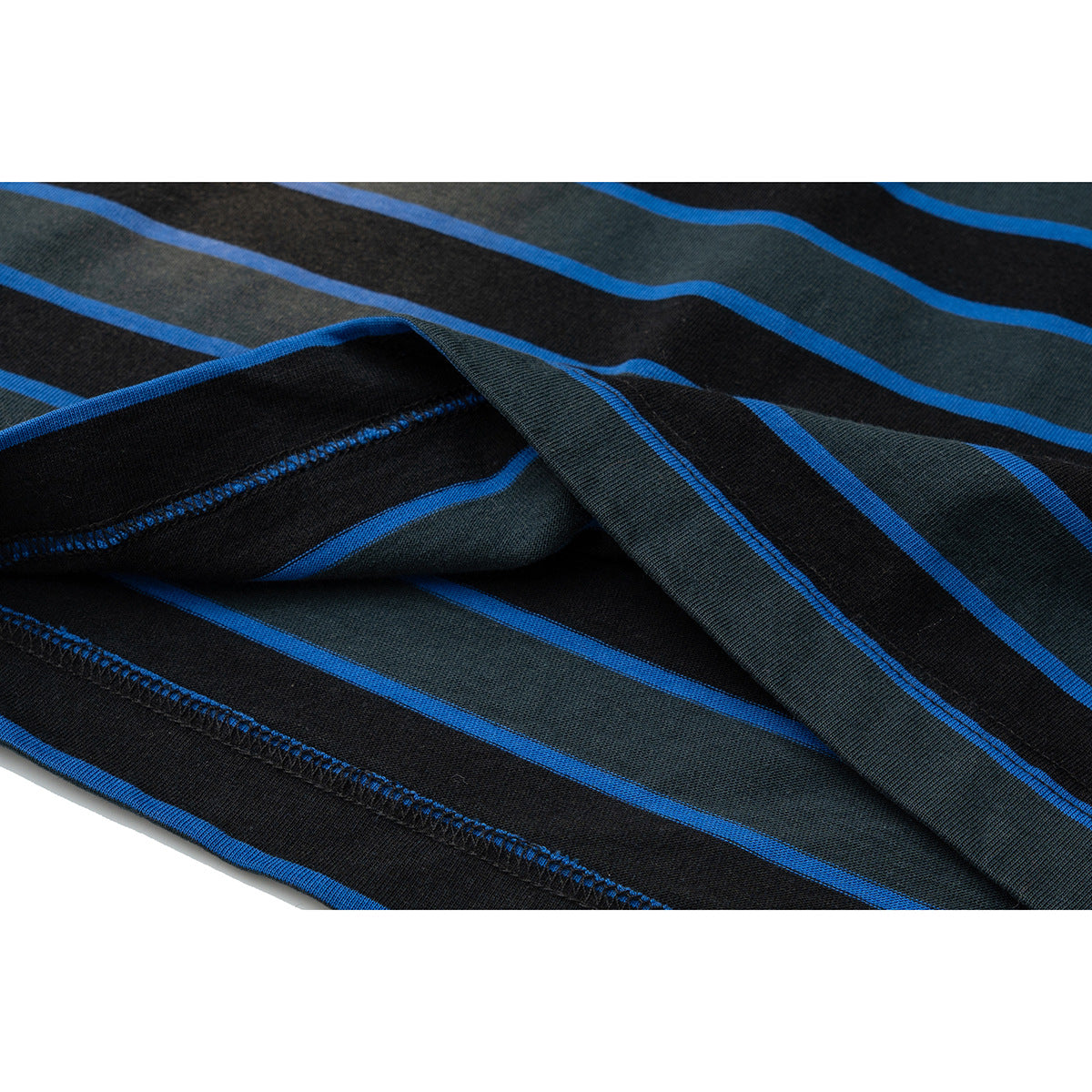 Close-up of the striped T-shirt’s folded hem and stitching, showing black, charcoal, and bright blue horizontal stripes.