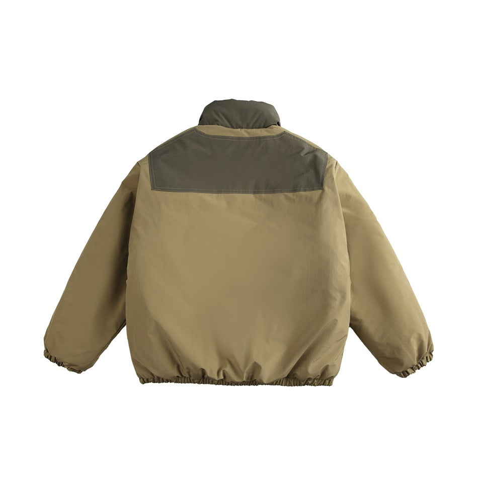 Back view of olive and tan stand-collar jacket with olive upper back yoke panel and elastic hem