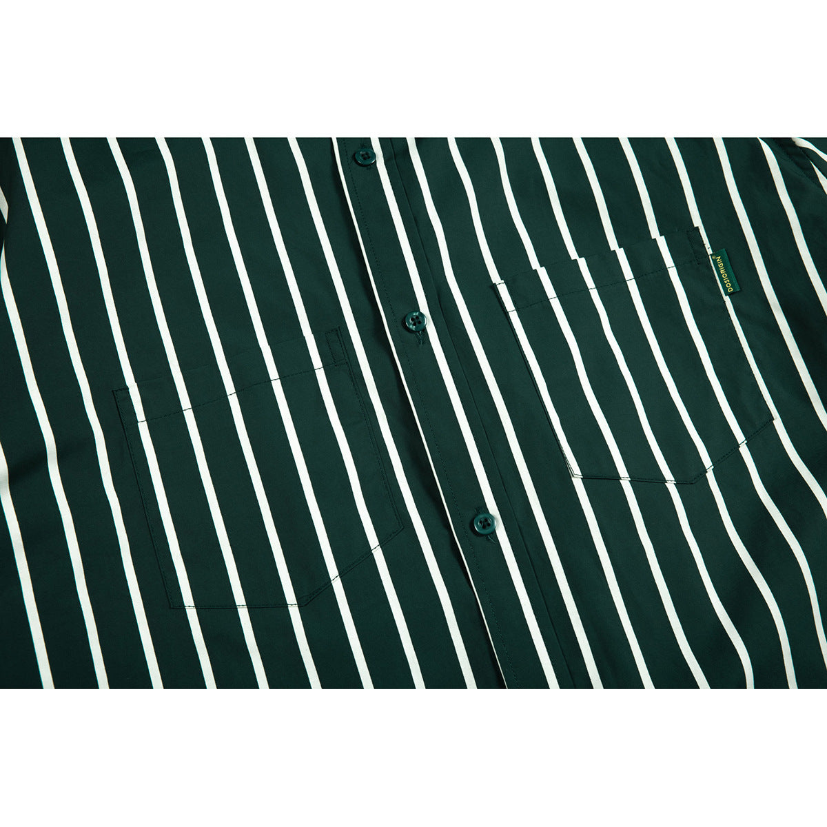 Close-up of a dark green striped shirt front showing its button placket and chest pockets.