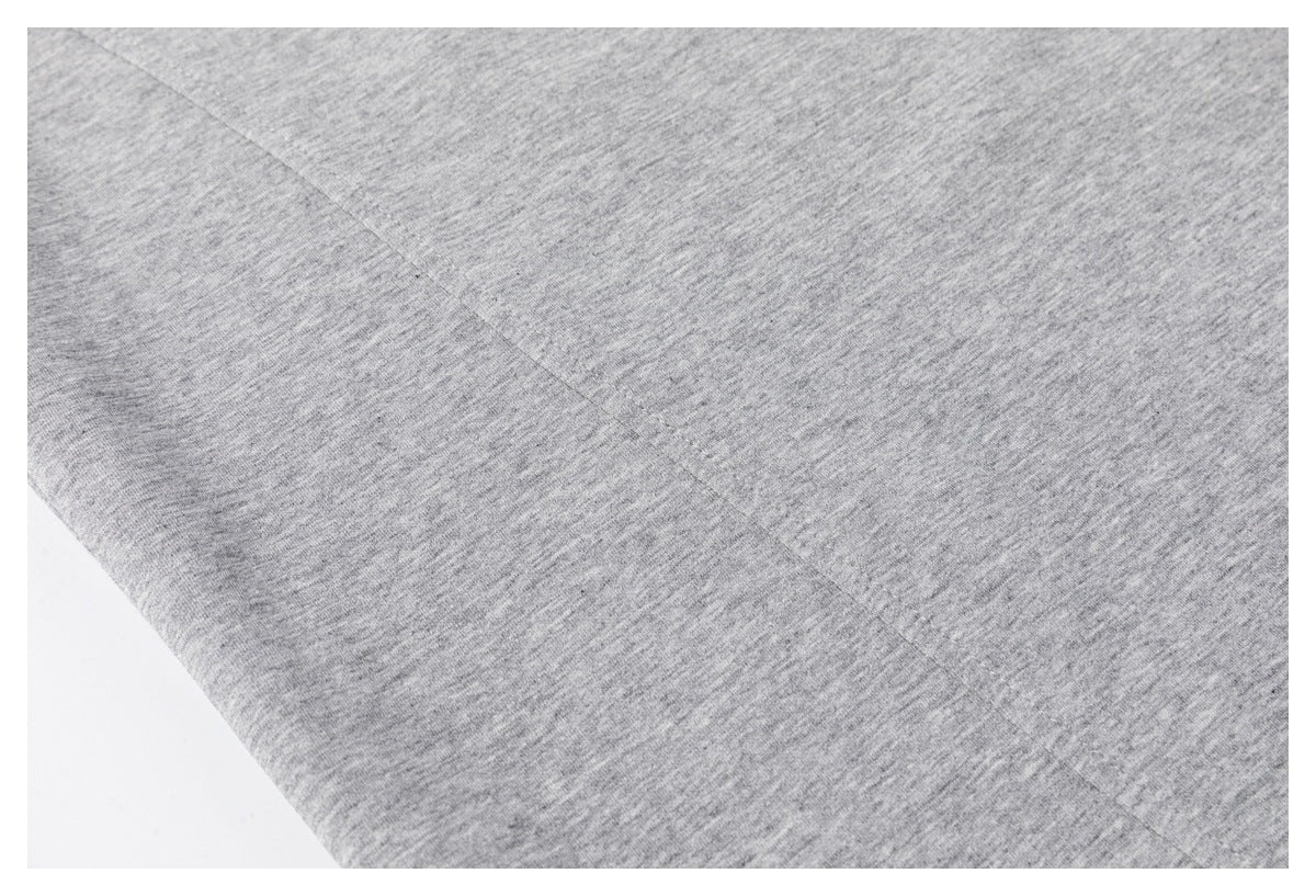 Close-up of the heather-gray T-shirt fabric and a diagonal stitched seam.