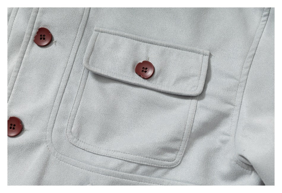 Close-up of a light gray jacket pocket with a buttoned flap and red-brown buttons.