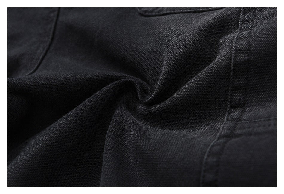 Close-up of textured black fabric showing folds and stitching.
