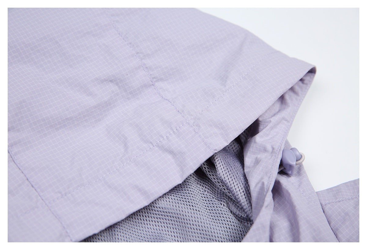 Close-up of lavender grid-patterned garment fabric, mesh lining, and a drawcord toggle.