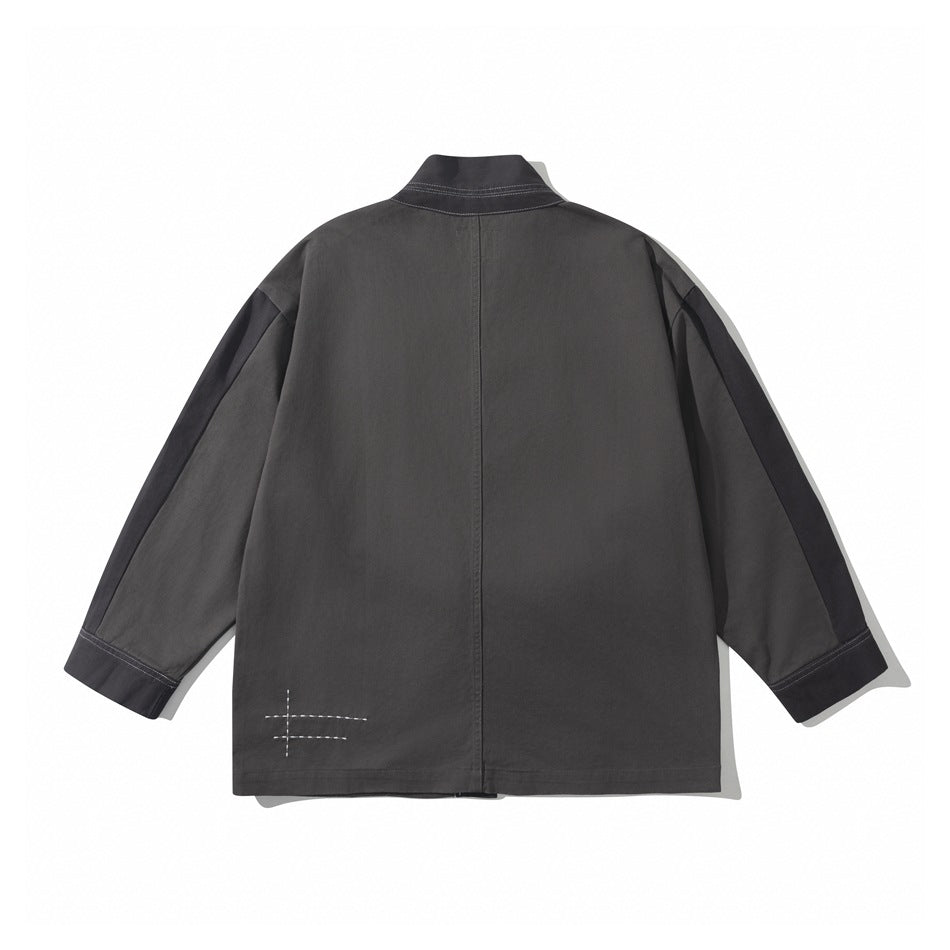 Back view of a charcoal jacket laid flat, showing a stand collar, dark sleeve panels, and white hem stitching.