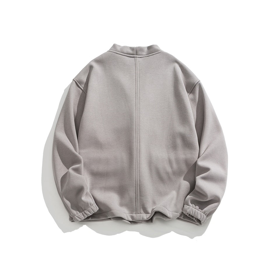 Back view of gray jacket with center back seam, drop shoulders and elastic cuffs, flat lay