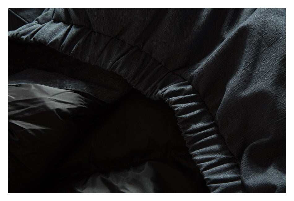 Close-up of the dark jacket’s gathered inner seam and lining.