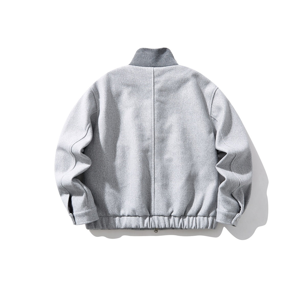 Back view of a light gray zip jacket with a ribbed stand collar and gathered hem.