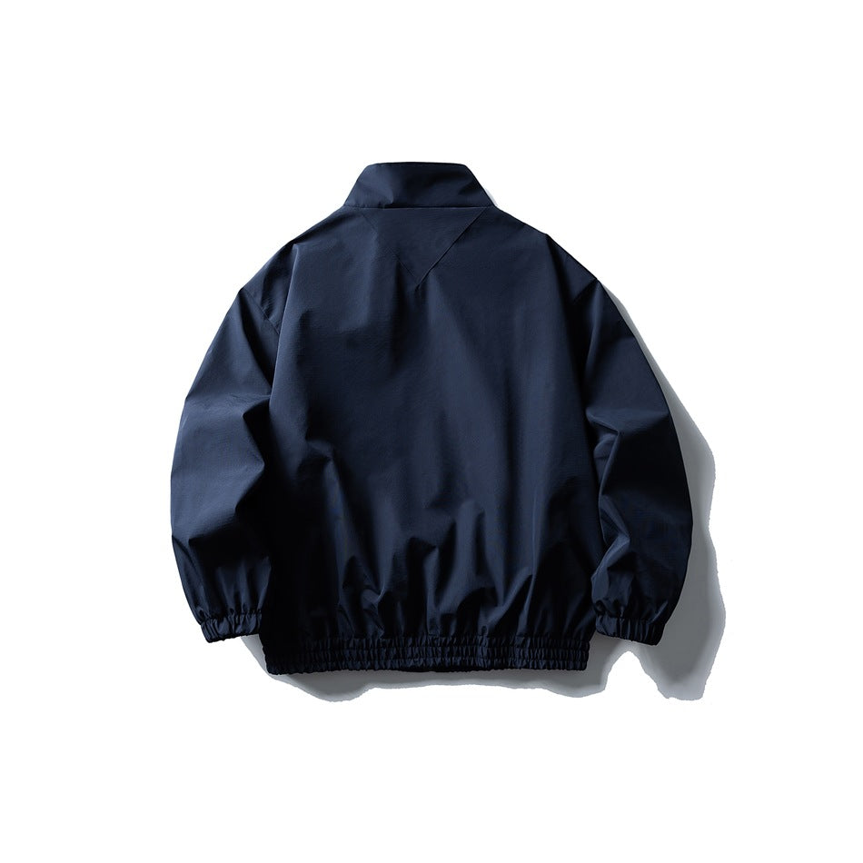 Back view of a dark navy stand-collar jacket with gathered cuffs and an elastic hem.