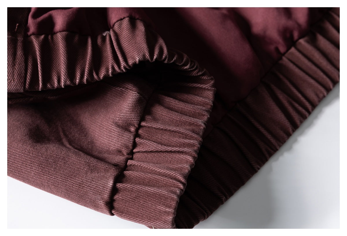Close-up of gathered elastic sections and seams on the burgundy garment.