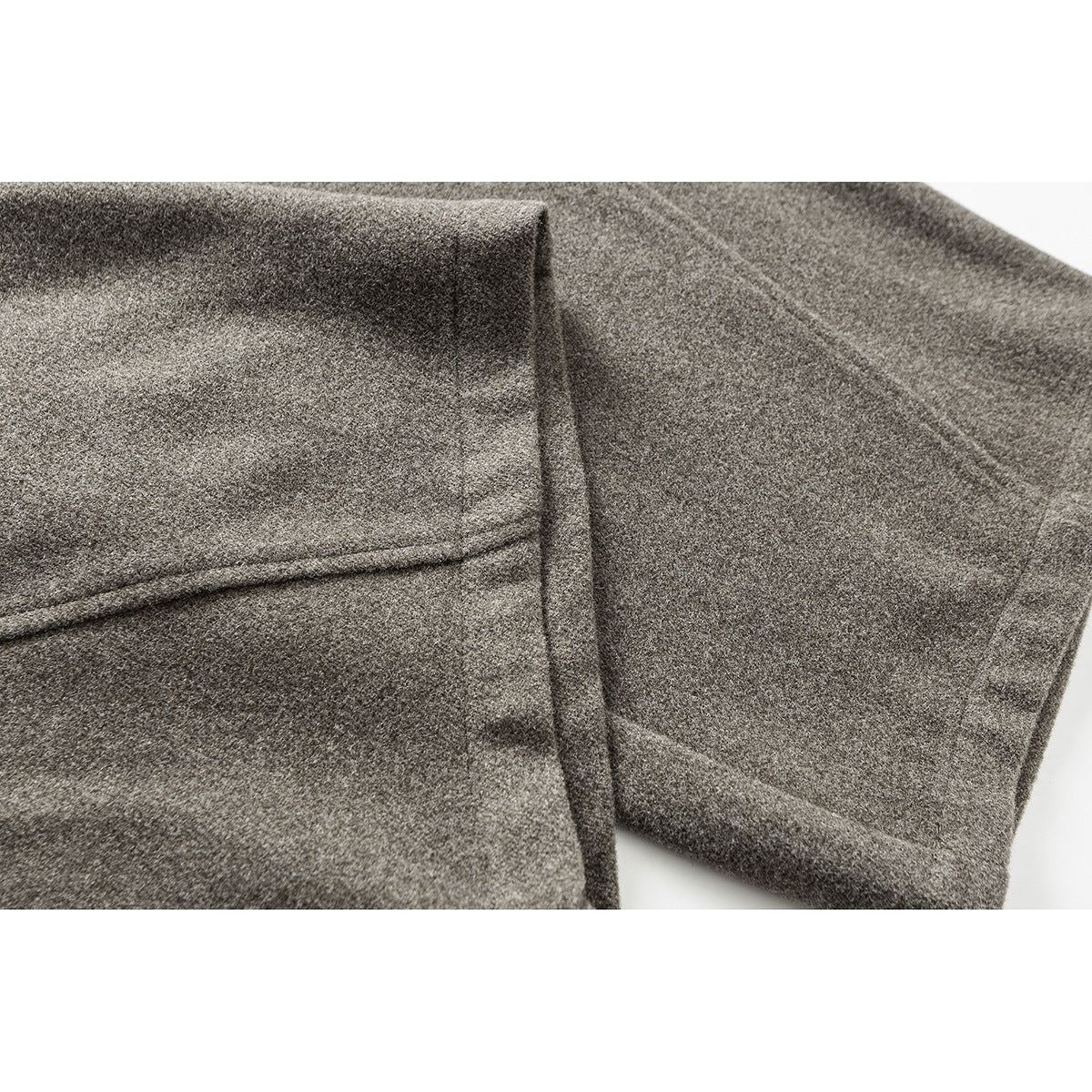 Close-up of the hem and seams on taupe wide-leg pants.