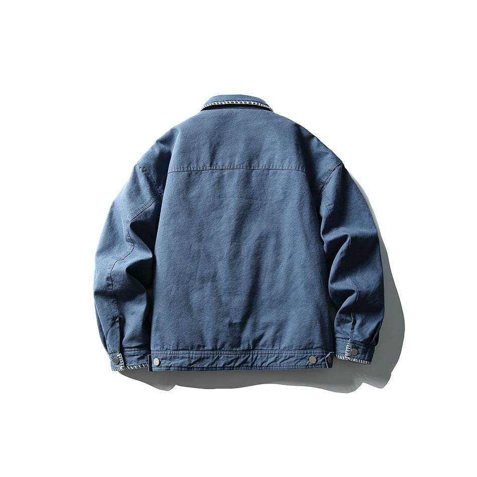 Back view of blue collared jacket with yoke seam, button cuffs and waist button tabs