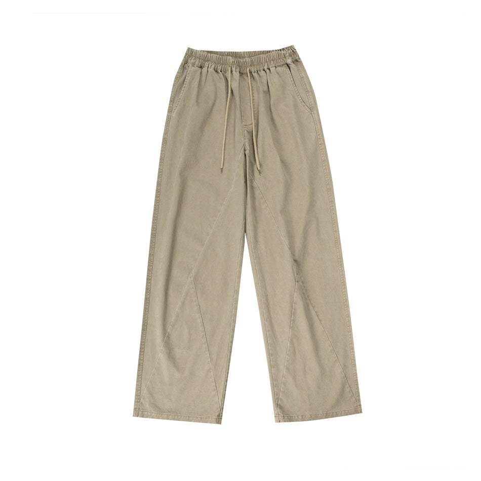 Khaki wide-leg drawstring pants with elastic waist and diagonal leg seams, flat lay front view