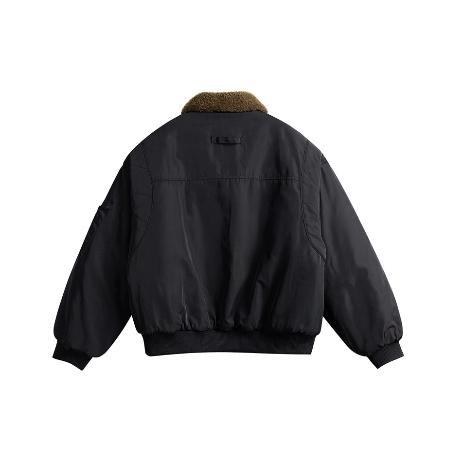 Back view of black bomber jacket with olive-brown fleece-like collar, back yoke seam, ribbed cuffs and hem
