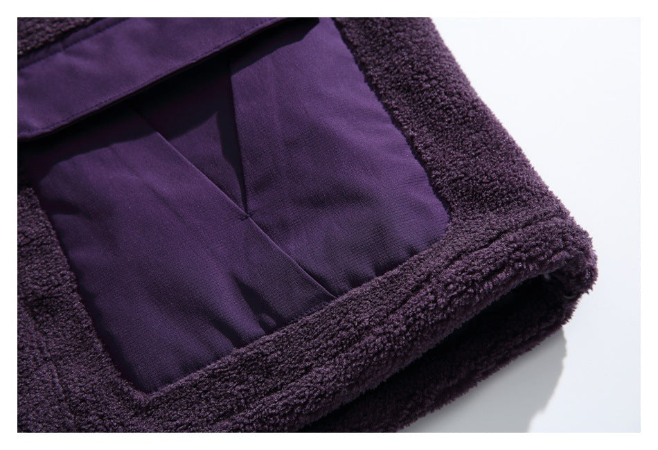 Close-up of a smooth purple jacket panel framed by fuzzy trim, including the lower edge.