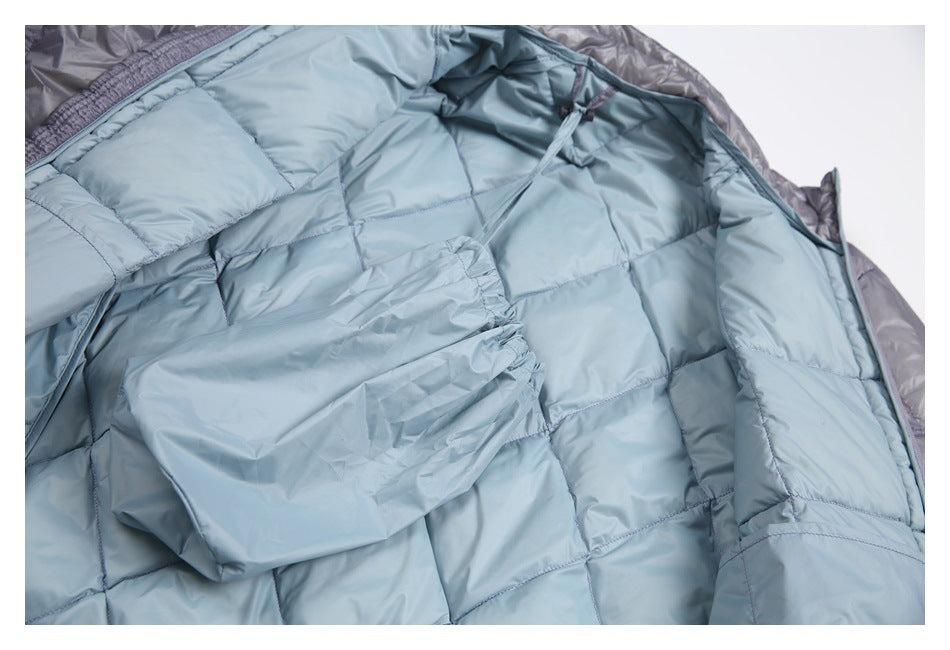 Inside view of the open jacket showing pale blue quilted lining and an interior pocket.