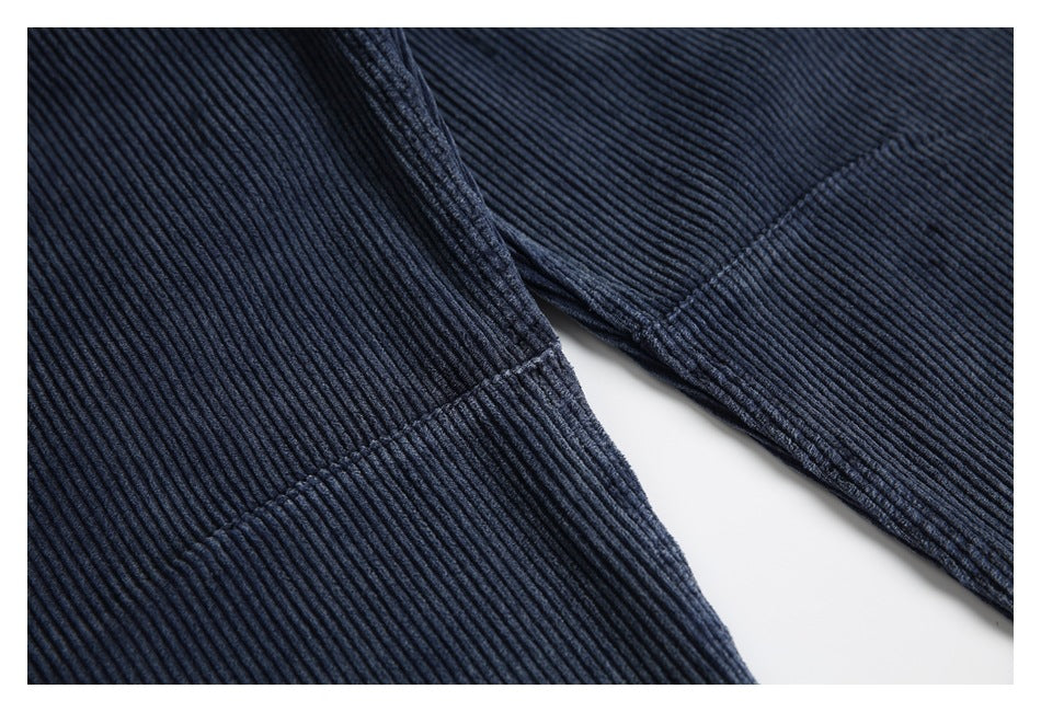 Close-up showing the ribbed texture and leg seam of navy trousers.