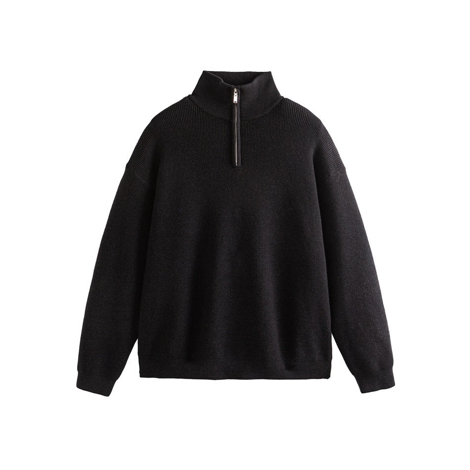 Front view of a black ribbed sweater with a high stand collar, short zipper and long sleeves.