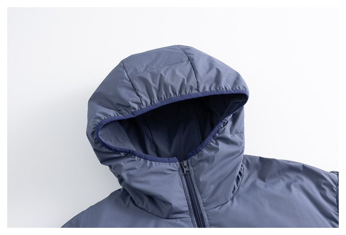 Close-up of the slate-blue padded jacket's hood, dark lining, and front zipper.