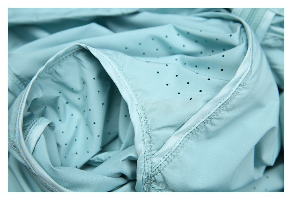 Close-up of a pale aqua garment showing stitched seams and small perforations.