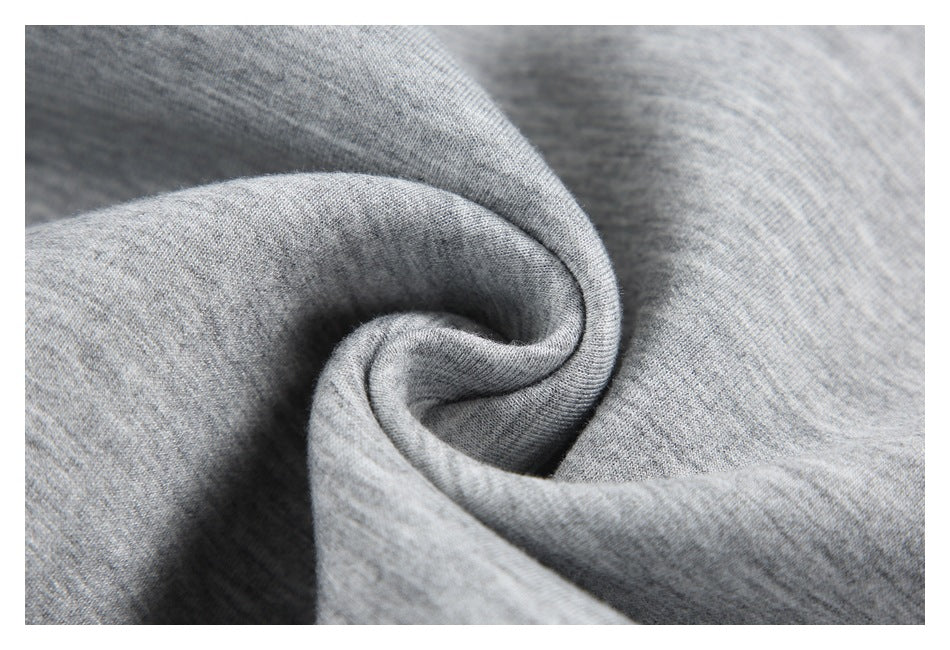 Heather gray fabric gathered into a soft spiral fold, showing its texture.
